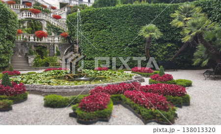 Ornate stone fountain with a cherub statue in the formal gardens of Villa Carlotta on Lake Como Ornate stone fountain with a cherub statue in the formal gardens of Villa Carlotta on Lake Como 138013320