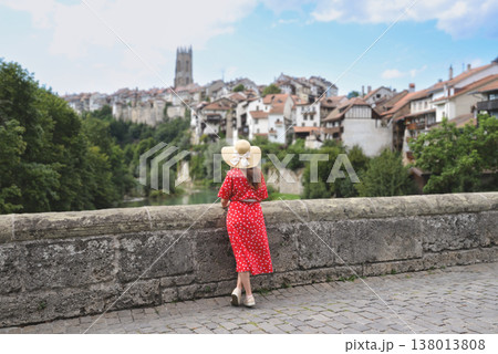 Woman in red polka dot dress overlooking Fribourg Old Town Woman in red polka dot dress overlooking Fribourg Old Town 138013808