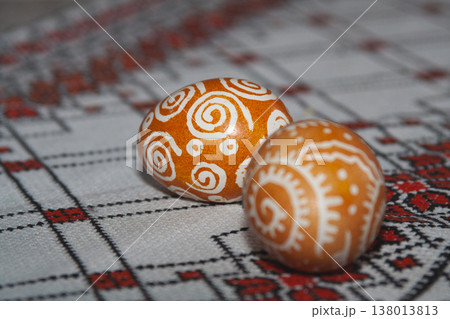 Two traditional Ukrainian pysanky on an embroidered tablecloth 138013813