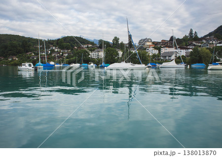 White sailboats anchored in a scenic harbor on Lake Thun with Mount Niesen in Switzerland White sailboats anchored in a scenic harbor on Lake Thun with Mount Niesen in Switzerland 138013870