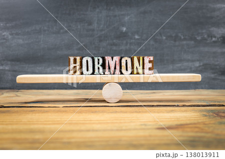 Hormone Balance Concept Shown By HORMONE Letter Blocks On Wooden Seesaw 138013911