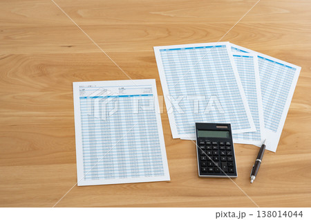 机の上のローン計算シートと電卓とペン 138014044