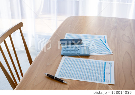 机の上のローン計算シートと電卓とスマホ 机の上のローン計算シートと電卓とスマホ 138014059