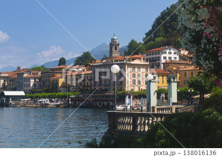 Picturesque waterfront view of Bellagio town on Lake Como with mountains under a cloudy sky 138016136