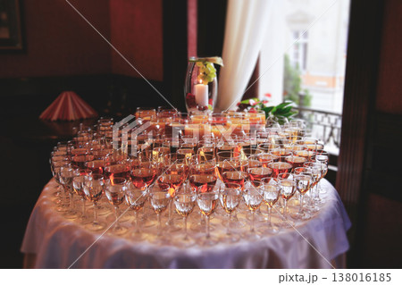 Close up of glass rows with wine and juice on a reception table Close up of glass rows with wine and juice on a reception table 138016185