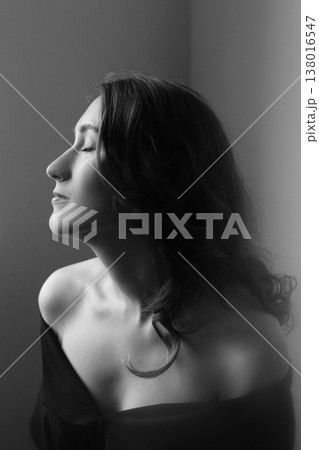 Black and white close up portrait of a pensive young girl Black and white close up portrait of a pensive young girl 138016547