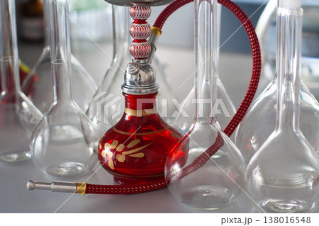 composition of red hookah and chemical glass flasks 138016548
