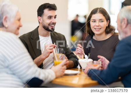 Family day. Multiage family drink coffee or juice in restaurant Family day. Multiage family drink coffee or juice in restaurant 138017570