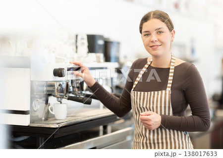 Woman barista making coffee Woman barista making coffee 138017633