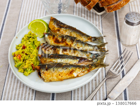 Delicious grilled sardines with guacamole and lemon closeup Delicious grilled sardines with guacamole and lemon closeup 138017666