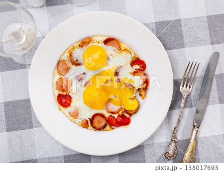 Fried eggs with tomato served with sausage Fried eggs with tomato served with sausage 138017693