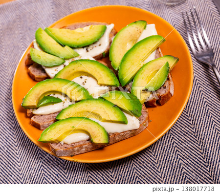 Toast with sliced avocado and cheese Toast with sliced avocado and cheese 138017718