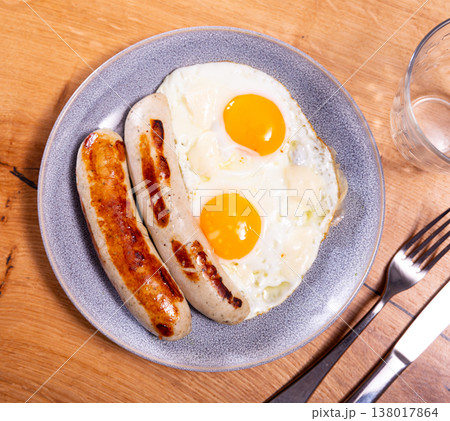 Healthy breakfast of scrambled eggs and sausages closeup 138017864