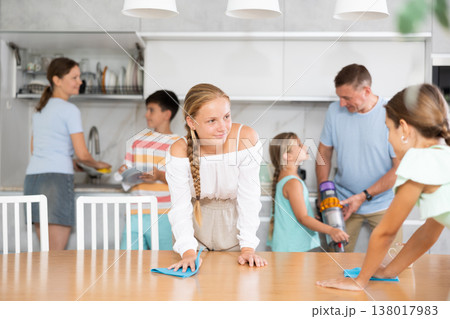 Children in large family help their parents to clean room 138017983