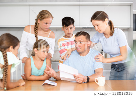 Big family reading upset letter 138018019