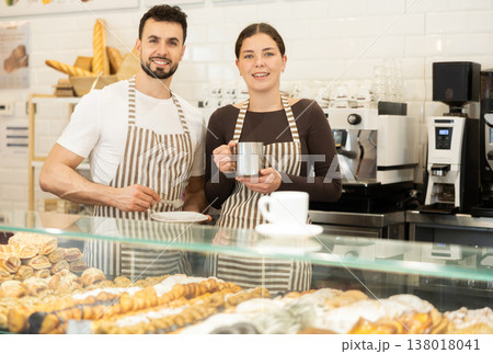 Two cafe employees preparing coffee and delicious pastries Two cafe employees preparing coffee and delicious pastries 138018041