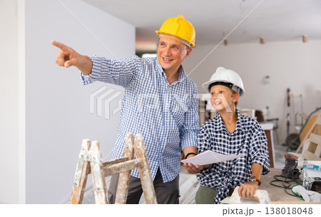 Father and son talking about space planning in new apartment Father and son talking about space planning in new apartment 138018048