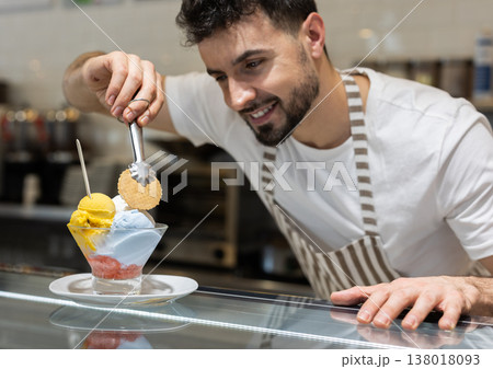 Guy chef or vendor serves ice cream 138018093