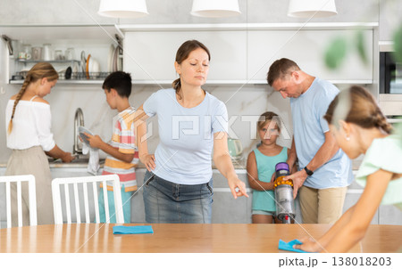 Strict mother tells her daughter how to properly dust off table Strict mother tells her daughter how to properly dust off table 138018203