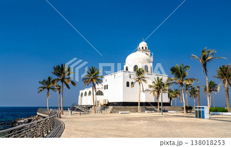 The white Island Mosque stands prominently along the Red Sea coast on the Jeddah Corniche in Saudi Arabia, framed by tropical palm trees under a clear blue sky. The white Island Mosque stands prominently along the Red Sea coast on the Jeddah Corniche in Saudi Arabia, framed by tropical palm trees under a clear blue sky. 138018253