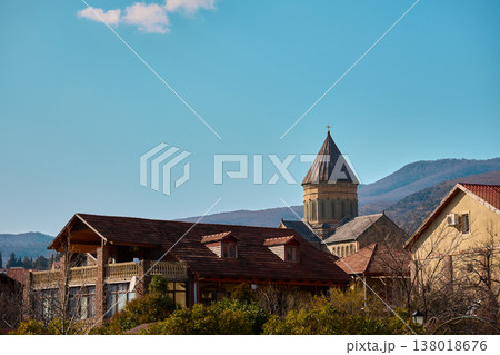 View of historic cathedral dome rising above red-tiled roofs and residential architecture 138018676