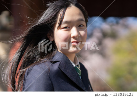 青春の1ページを飾る記念写真。新学期の始まりを祝い、桜の木の下でポーズをとる女子高生 青春の1ページを飾る記念写真。新学期の始まりを祝い、桜の木の下でポーズをとる女子高生 138019123