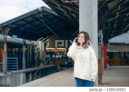 駅のホームでスマホを操作する女性 138019501