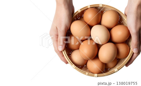 A hand grips a basket brimming with brown eggs, highlighting National Egg Month A hand grips a basket brimming with brown eggs, highlighting National Egg Month 138019755