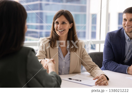 Middle-aged businesswoman shaking hands with female client 138021222