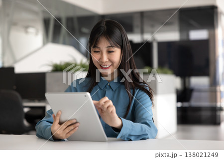 Positive young Asian manager woman using online service for business Positive young Asian manager woman using online service for business 138021249