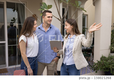 Real estate agent showing residential property to couple Real estate agent showing residential property to couple 138021268