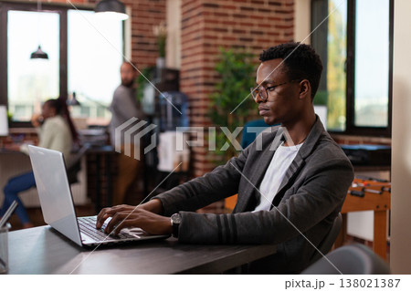 Entrepreneur man brainstorming ideas for marketing project while analyzing company turnover using laptop computer. Businessman working in startup office planning management collaboration Entrepreneur man brainstorming ideas for marketing project while analyzing company turnover using laptop computer. Businessman working in startup office planning management collaboration 138021387
