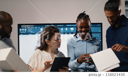 Portrait of real estate developers team planning a high density housing project, attention to sustainability and urban infrastructure growth. Blueprints for residential master plan. 138021430