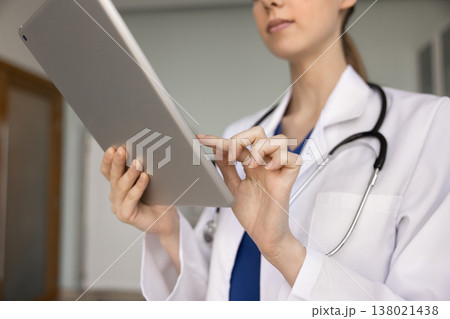 Nurse or doctor working on tablet device in clinic Nurse or doctor working on tablet device in clinic 138021438