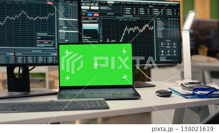 Close up of green screen laptop and trading app in asset management company office. Mockup device on desk used by brokerage firm workers tracking stock exchange activity using analytical tools 138021619