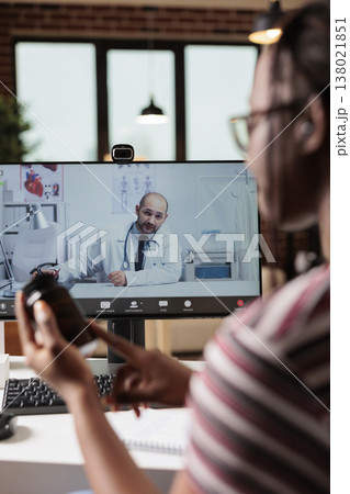 Online medical consultation, patient discussing prescripted pills with doctor on video call. Telemedicine, remote therapist appointment, live communication with gp on computer at home 138021851