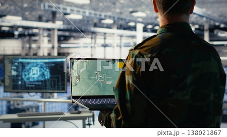 Army specialist in data center integrating AI into radar systems for missile tracking. Military soldier in server room analyzing aerial movement through artificial intelligence systems, camera B 138021867