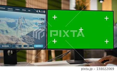 Technician working on futuristic wind turbine concept on isolated screen PC designed for clean energy output. Man in office uses chroma key computer to research cutting edge VAWT innovation, camera B 138022069
