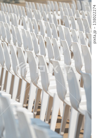 Large scale seating setup with many chairs prepared for an audience in a big event or conference environment. Large scale seating setup with many chairs prepared for an audience in a big event or conference environment. 138022274