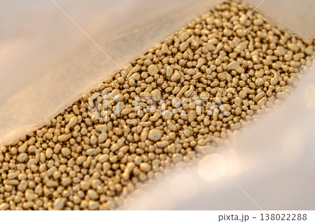 Brass metal granules stored in a plastic bag for industrial or manufacturing use showing raw material and material handling. Brass metal granules stored in a plastic bag for industrial or manufacturing use showing raw material and material handling. 138022288