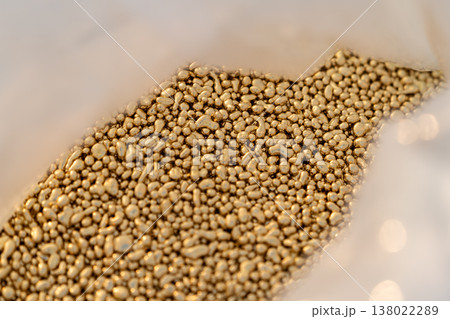 Brass metal granules stored in a plastic bag for industrial or manufacturing use showing raw material and material handling. Brass metal granules stored in a plastic bag for industrial or manufacturing use showing raw material and material handling. 138022289