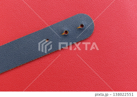 shiny red leather background with dark blue strap 138022551