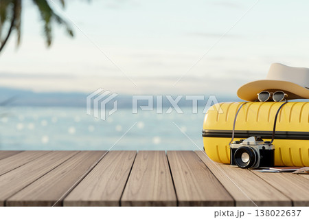 Camera with sunglasses and tourist hat over luggage on wooden table or boardwalk across sea and sky. Camera with sunglasses and tourist hat over luggage on wooden table or boardwalk across sea and sky. 138022637