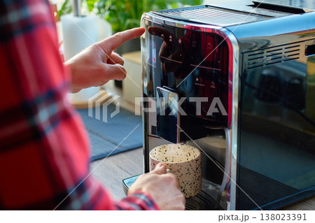 Man making coffee with espresso machine at home 138023391