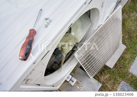 Open outdoor heat pump unit with fan and screwdriver during service Open outdoor heat pump unit with fan and screwdriver during service 138023406