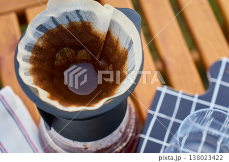 Top view of pour over coffee filter in dripper on wooden table 138023422