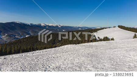 Snowy landscape with mountains and clear sky at sunny day 138023691