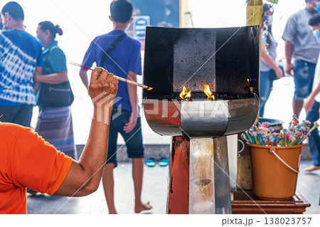 Lighting oil flame at temple 138023757