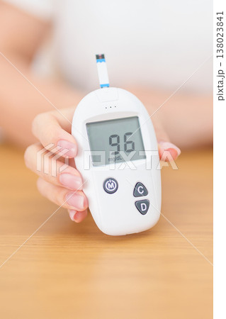 Hand checking Diabetes or Blood glucose self testing by digital blood glucose meter with lancet pen. high blood sugar level, World Diabetes Day, Glycemia, Hypoglycemia, Hyperglycemia and insulin Hand checking Diabetes or Blood glucose self testing by digital blood glucose meter with lancet pen. high blood sugar level, World Diabetes Day, Glycemia, Hypoglycemia, Hyperglycemia and insulin 138023841