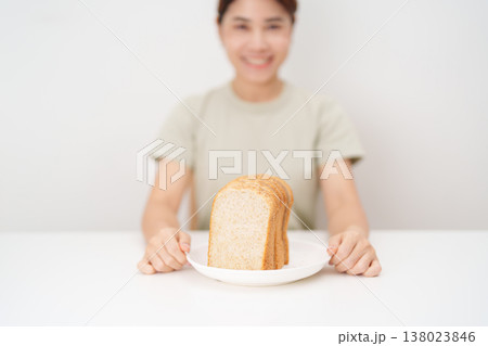 Happy smiling woman with whole wheat bread. Weight loss management, Dieting, Healthy eating, Calorie control, Fitness food, High fiber, Wellness, Lifestyle, Metabolism and Glycemic Index 138023846